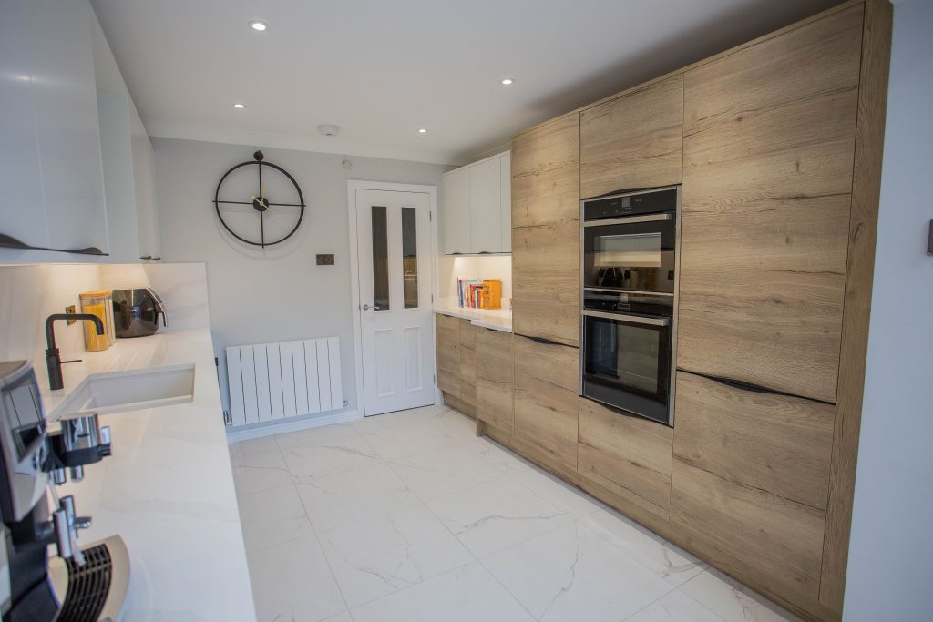 wooden cabinet kitchen with marble flooring