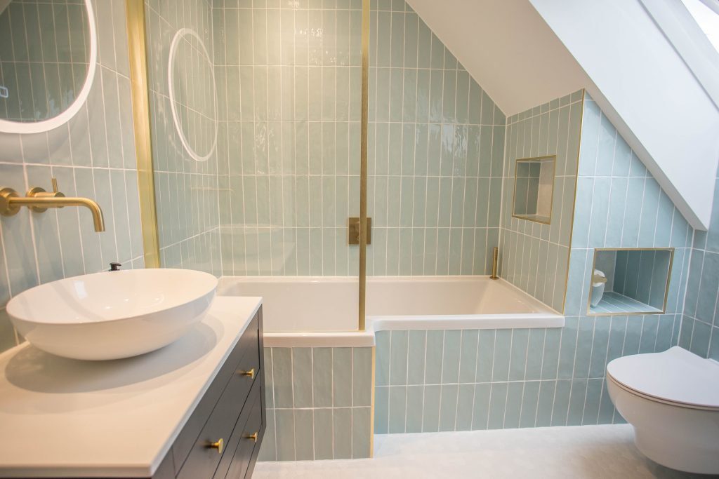 light blue tiled bath with white sink