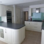 light green and white kitchen with grey worktop