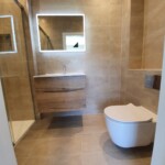 brown tiled bathroom with square mirror