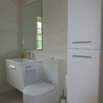 white tall unit with sink and toilet