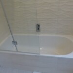 white bath with glass shower door