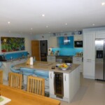 light blue kitchen with wine fridge