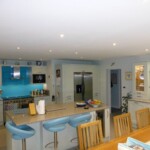 arial view of light blue kitchen with wooden dining table