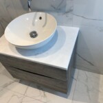 white basin on dark draws