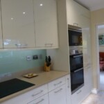 tall white cabinet with built in oven