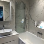 bathroom with glass door and silver shower head