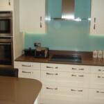 blue splash back board in white kitchen