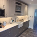 grey modern kitchen leading to hallway