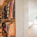 built in wardrobe with clothes in