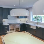 dark kitchen with golden handled cabinets