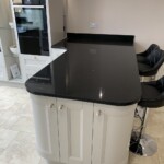 curved breakfast bar with black worktop
