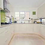 large white and silver kitchen with green clock