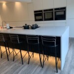white and black kitchen with middle island hob