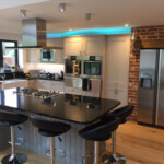 grey kitchen with brick work