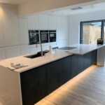 middle island with lights on the bottom in kitchen