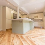 light green island with white cabinets in kitchen