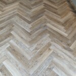wooden flooring with light blue cabinets