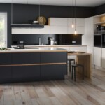 black and white kitchen with wooden floor